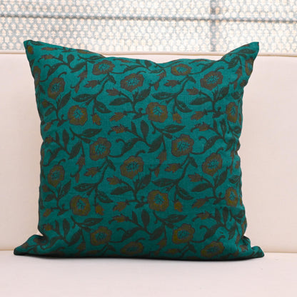 Teal wild rose vine block print linen pillow cover styled on a sofa