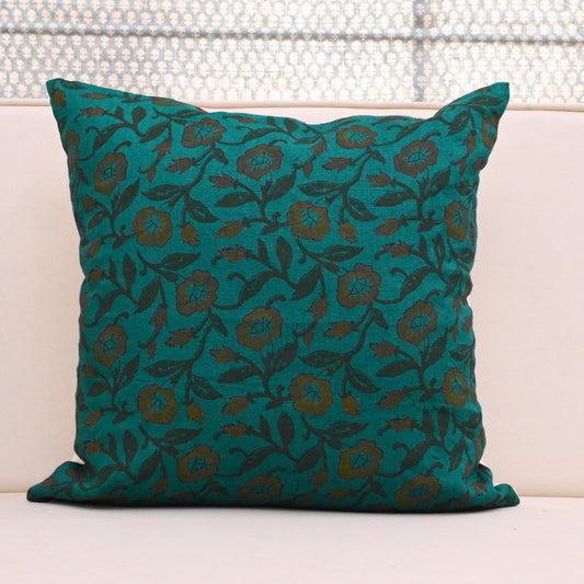 Teal wild rose vine block print linen pillow cover styled on a sofa
