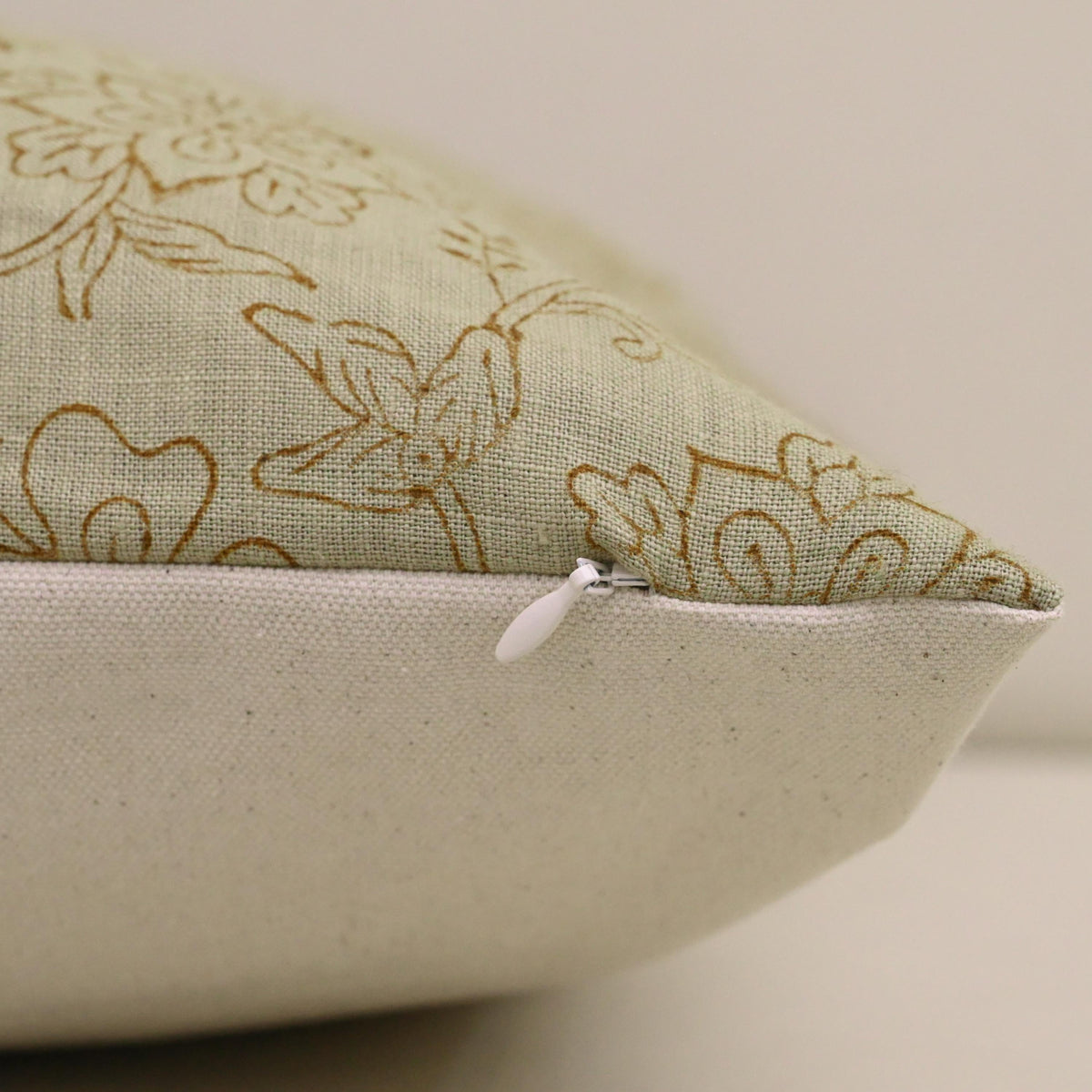 Close-up of hand block printed chintz jaal vine pattern on sage linen