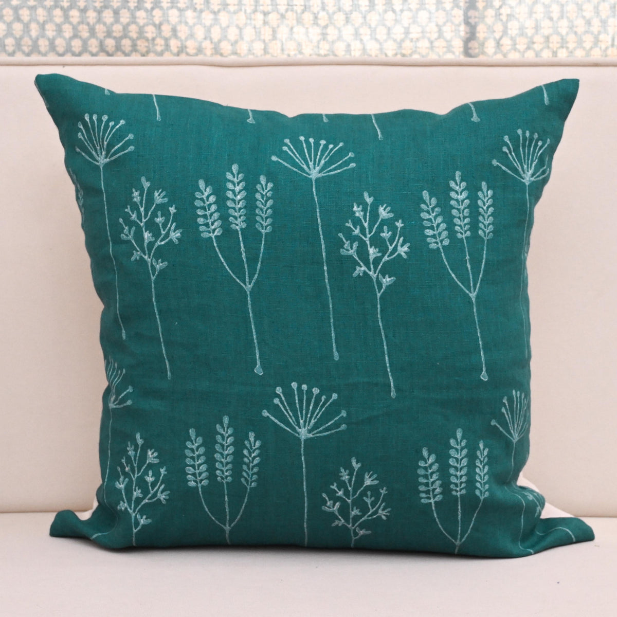 Teal wild meadow block print linen pillow cover styled on a sofa