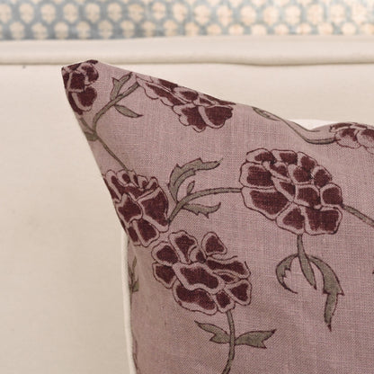 Mauve carnation block print linen pillow cover styled on a sofa